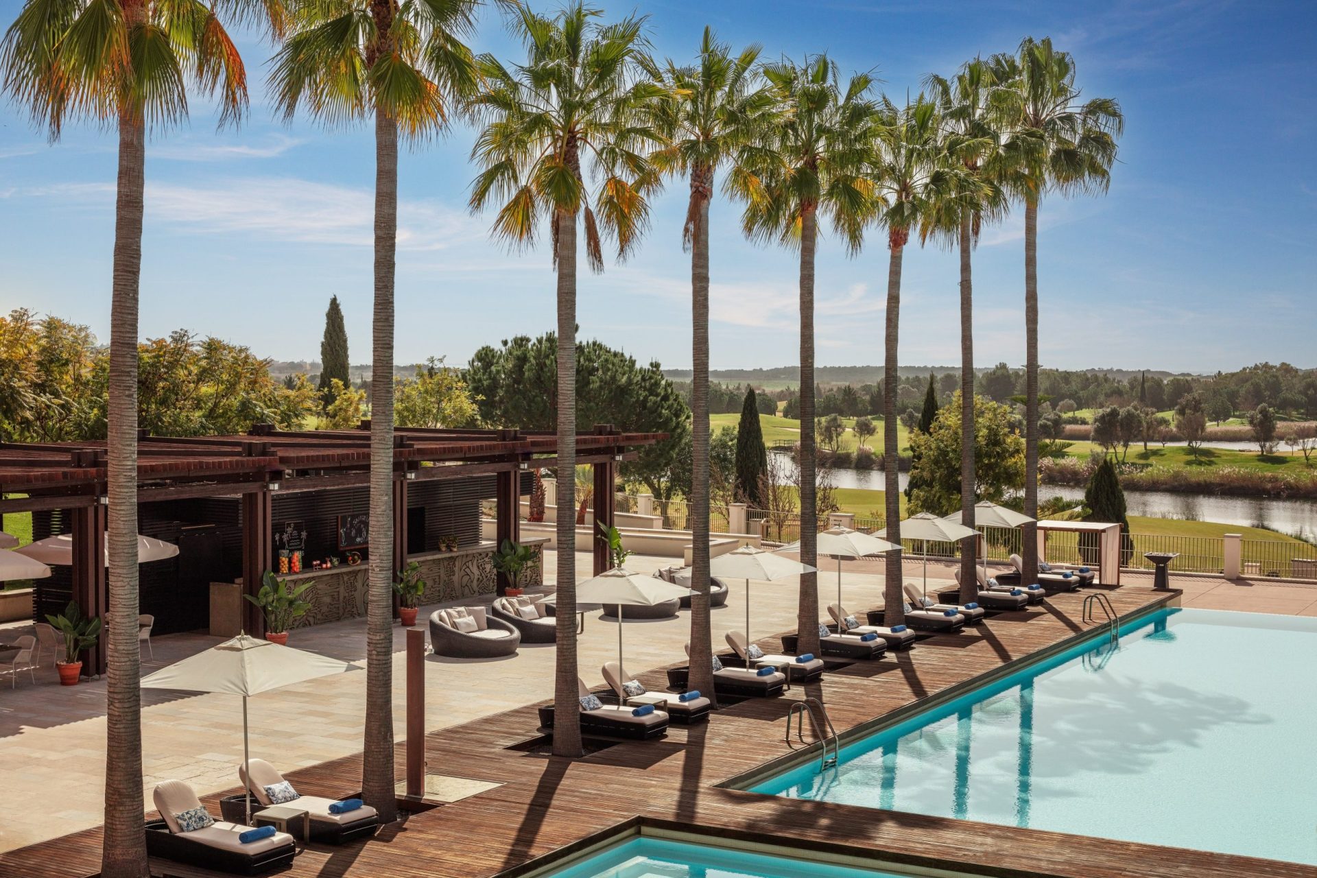 Victoria_Golf_Resort_&_Spa_Main_Pool_Palms_Bar_Wide_Hero