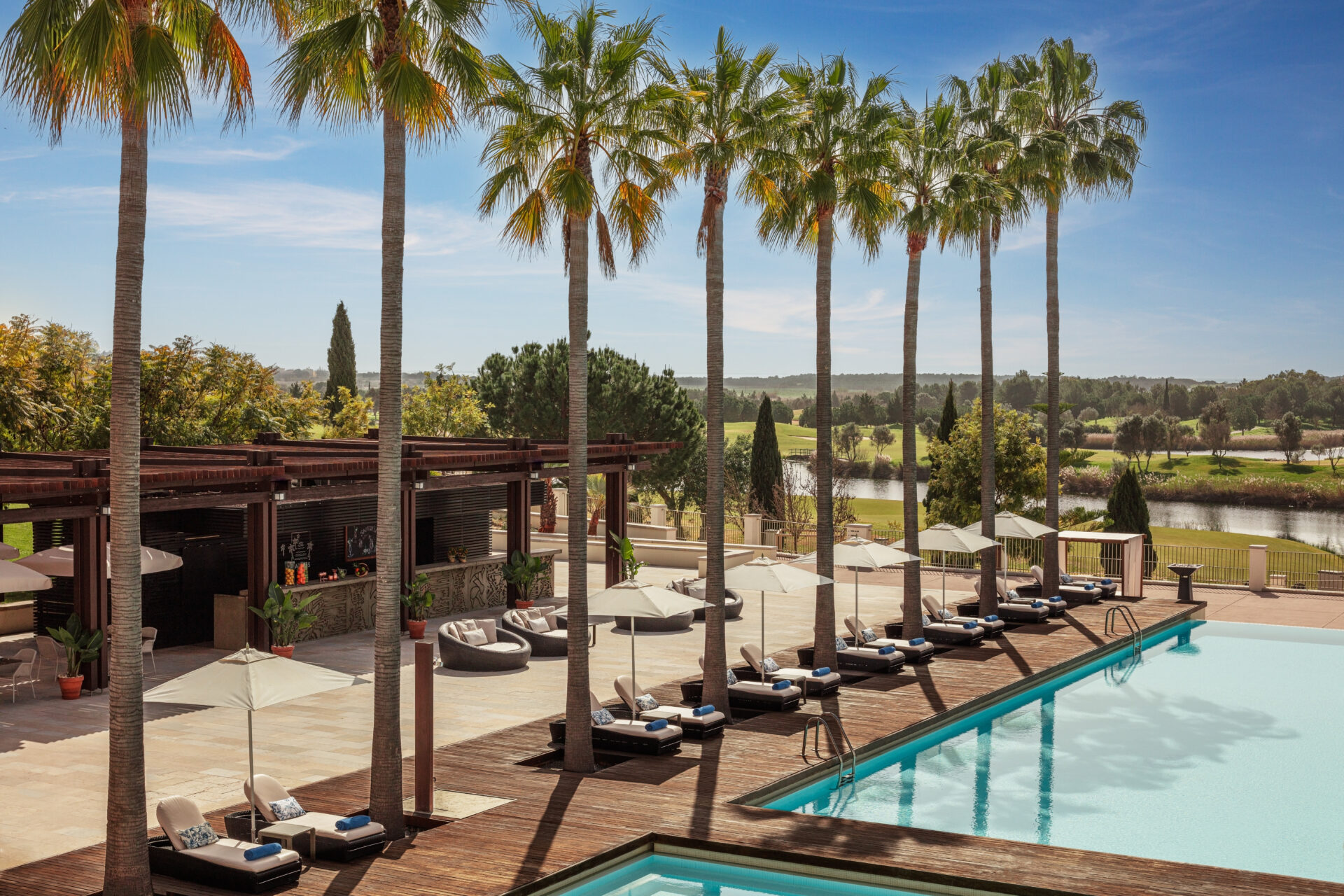 Victoria_Golf_Resort_&_Spa_Main_Pool_Palms_Bar_Wide_Hero